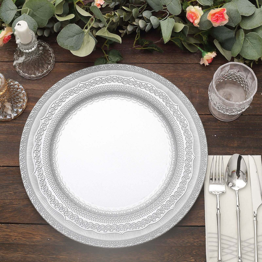 Elegant decorative plate on a wooden table with floral accents.
