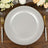 Silver charger plate with pearl rim on wooden table setting.