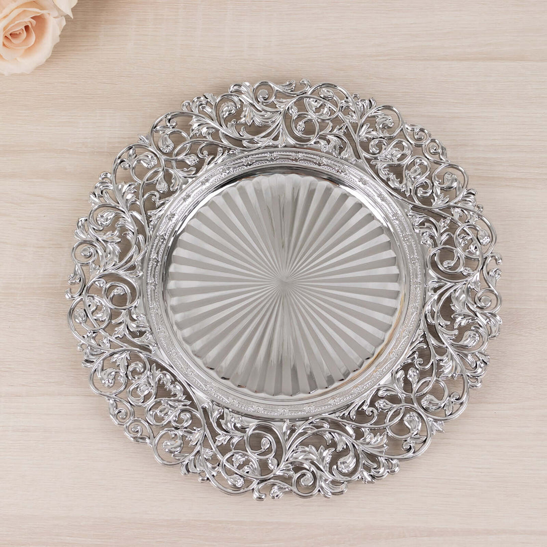 Ornate silver serving platter with intricate floral design.