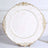 Elegant white plate with gold ornate edges on a stand.