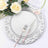 Elegantly styled silver plate with pink-handled fork and knife, adorned with roses.