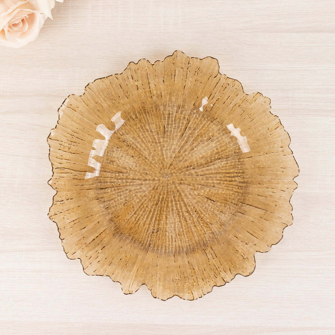 Amber glass decorative plate with ruffled edges.