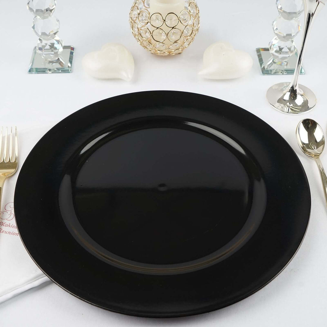 Black decorative plate on a dining table setting.
