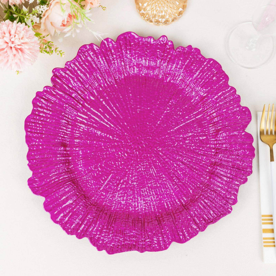 Bright pink decorative plate with intricate texture design.