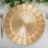 Gold decorative charger plate with a sunburst design.