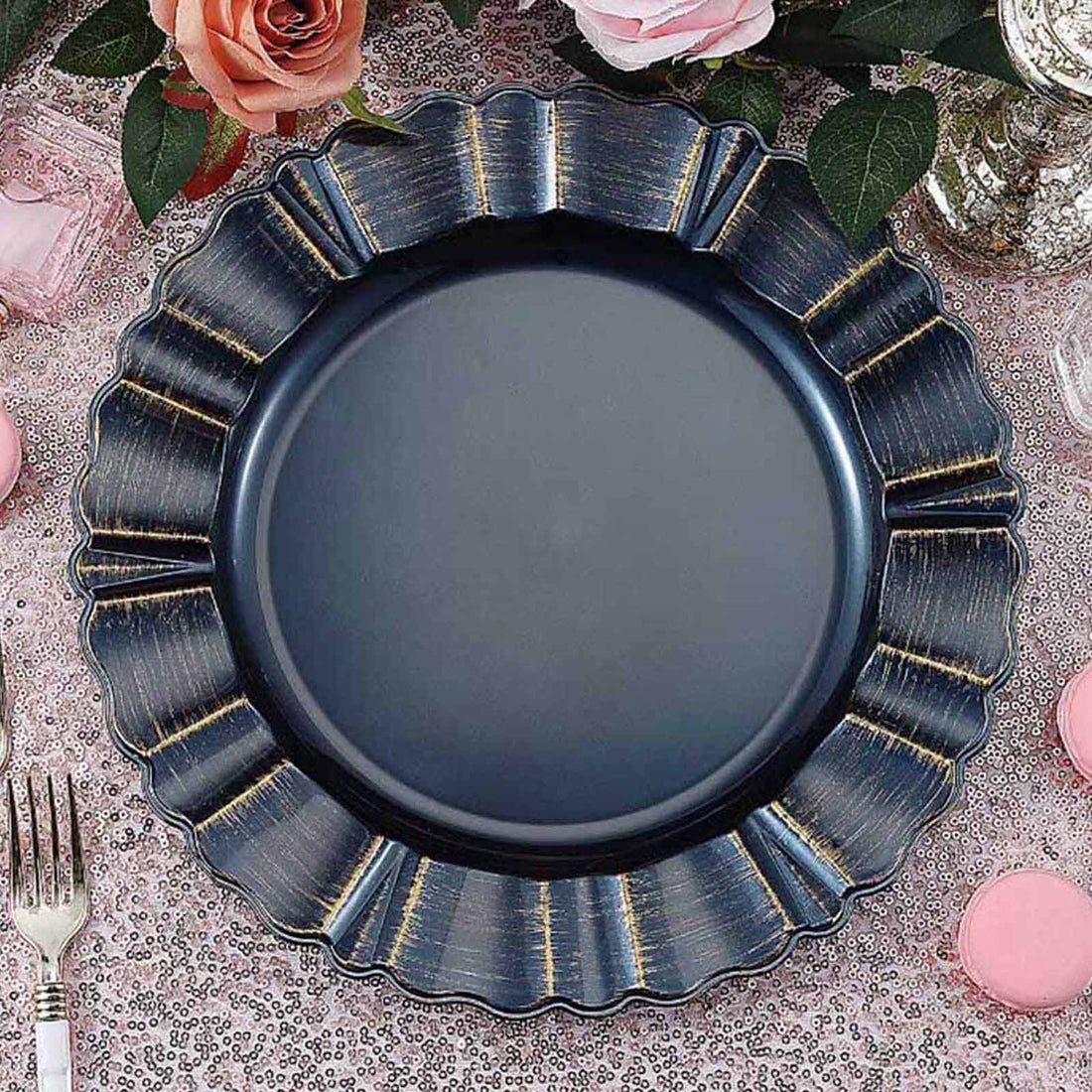 Navy blue decorative plate with scalloped edges on a pink glitter tablecloth.
