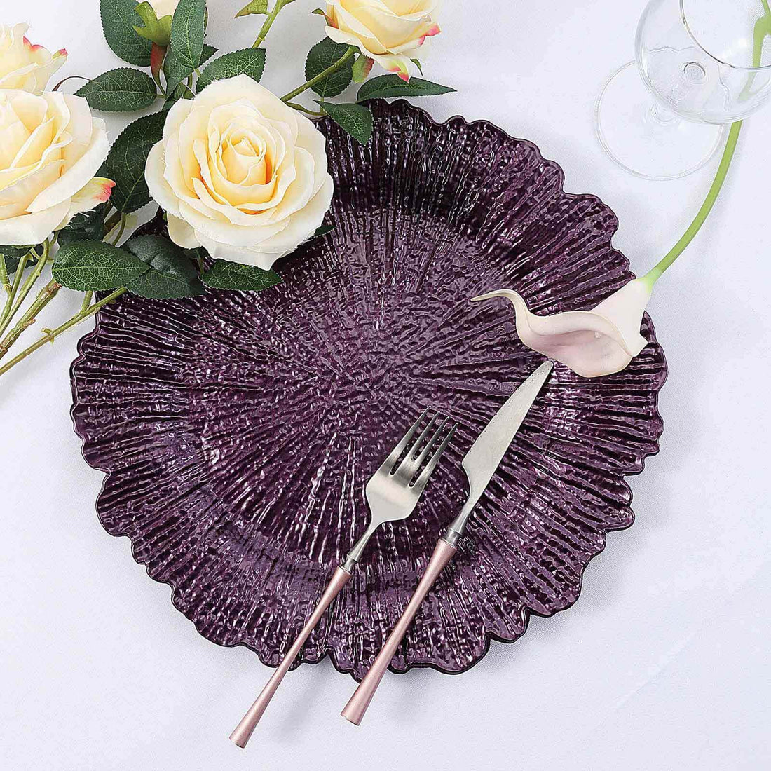 Purple textured plate with fork and knife, adorned with decorative roses.