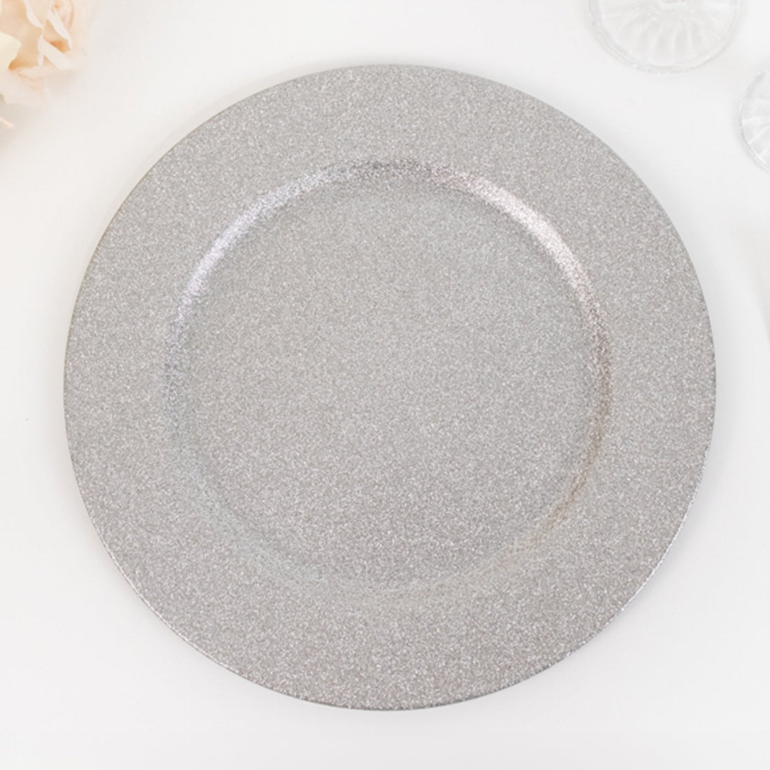 Silver glitter charger plate on a white background.