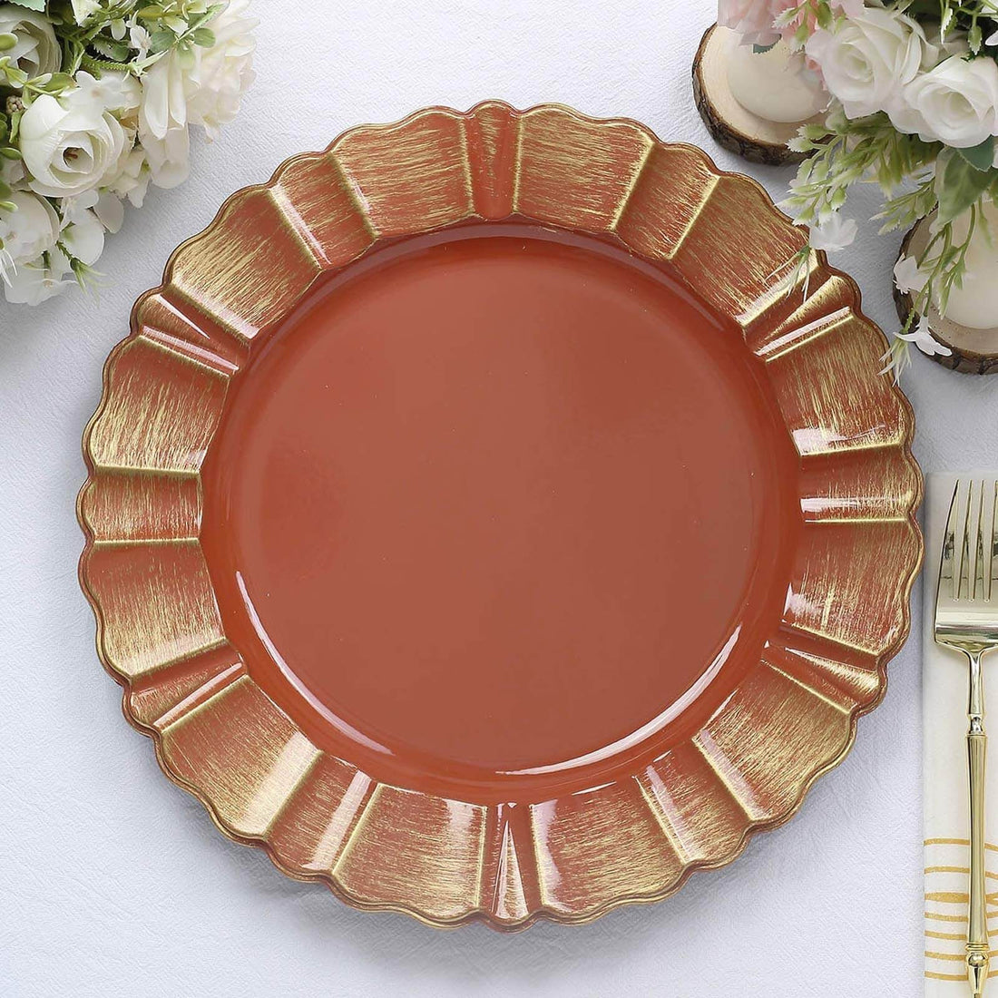Decorative orange plate with gold trim on a textured table setting.