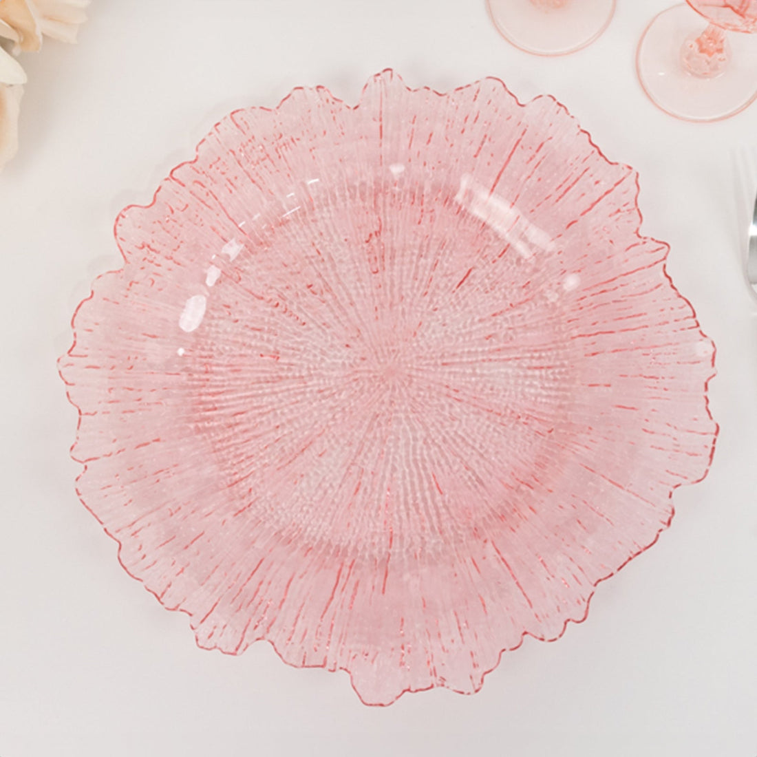 Red textured decorative plate with a ruffled edge on a plain background