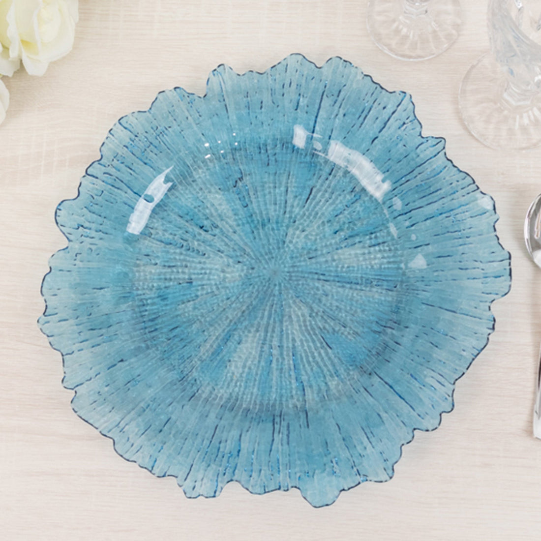 Blue decorative plate with a textured floral design.