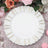 Elegant white plate with gold rim detail on a floral table setting.