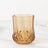 Amber geometric glass tumbler on a white background.