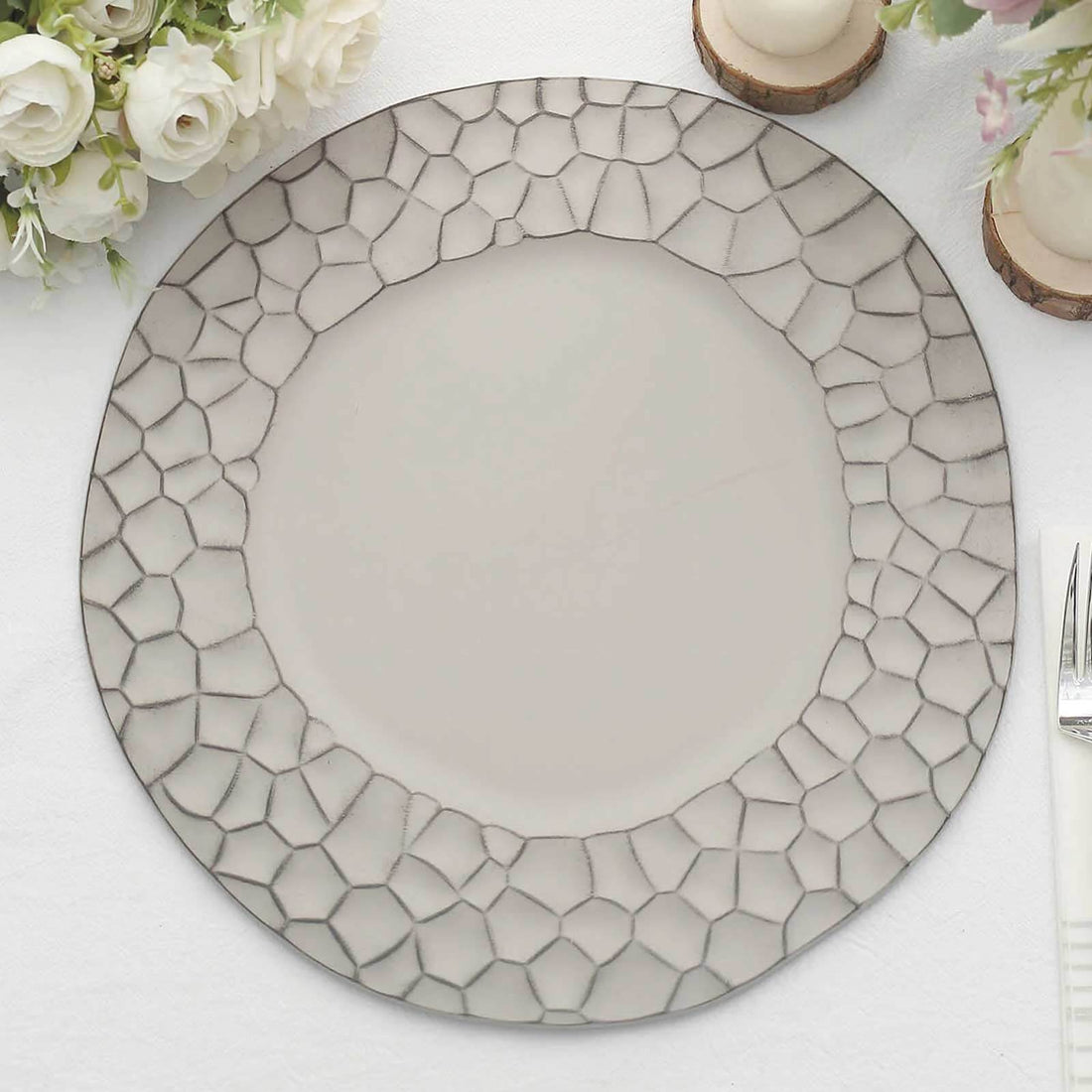 Decorative round plate with a textured edge design.
