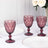 Set of three vintage-style purple goblets on a dining table.