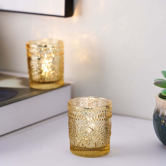 Gold decorative candle holder with intricate design on a minimalist tabletop.
