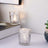 Decorative glass candle holder with intricate design and soft glow.