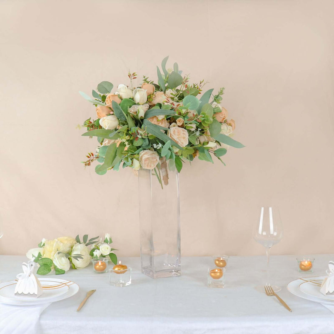 Elegant floral arrangement in a clear vase on a dining table.