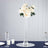 Elegant white rose floral arrangement in a tall glass vase.