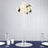 Elegant white rose floral centerpiece in a tall glass vase.