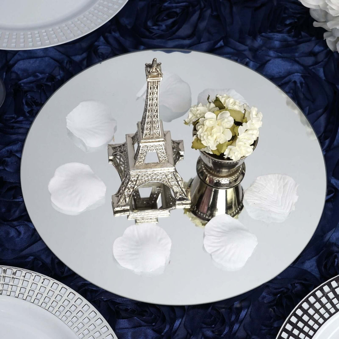 Eiffel Tower replica and flower vase on a mirrored table centerpiece.