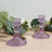 Purple crystal candle holders with intricate designs on wooden surface.