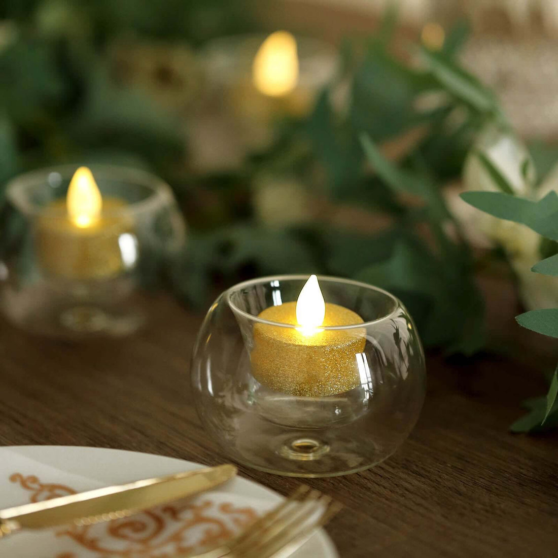 LED tealight candle in a glass holder, perfect for table decor.
