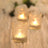 Decorative glass candle holders with soft glowing lights.