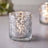 Crystal candle holder with shimmering lights and textured glass design.
