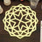 Geometric gold table centerpiece with star pattern on wooden table