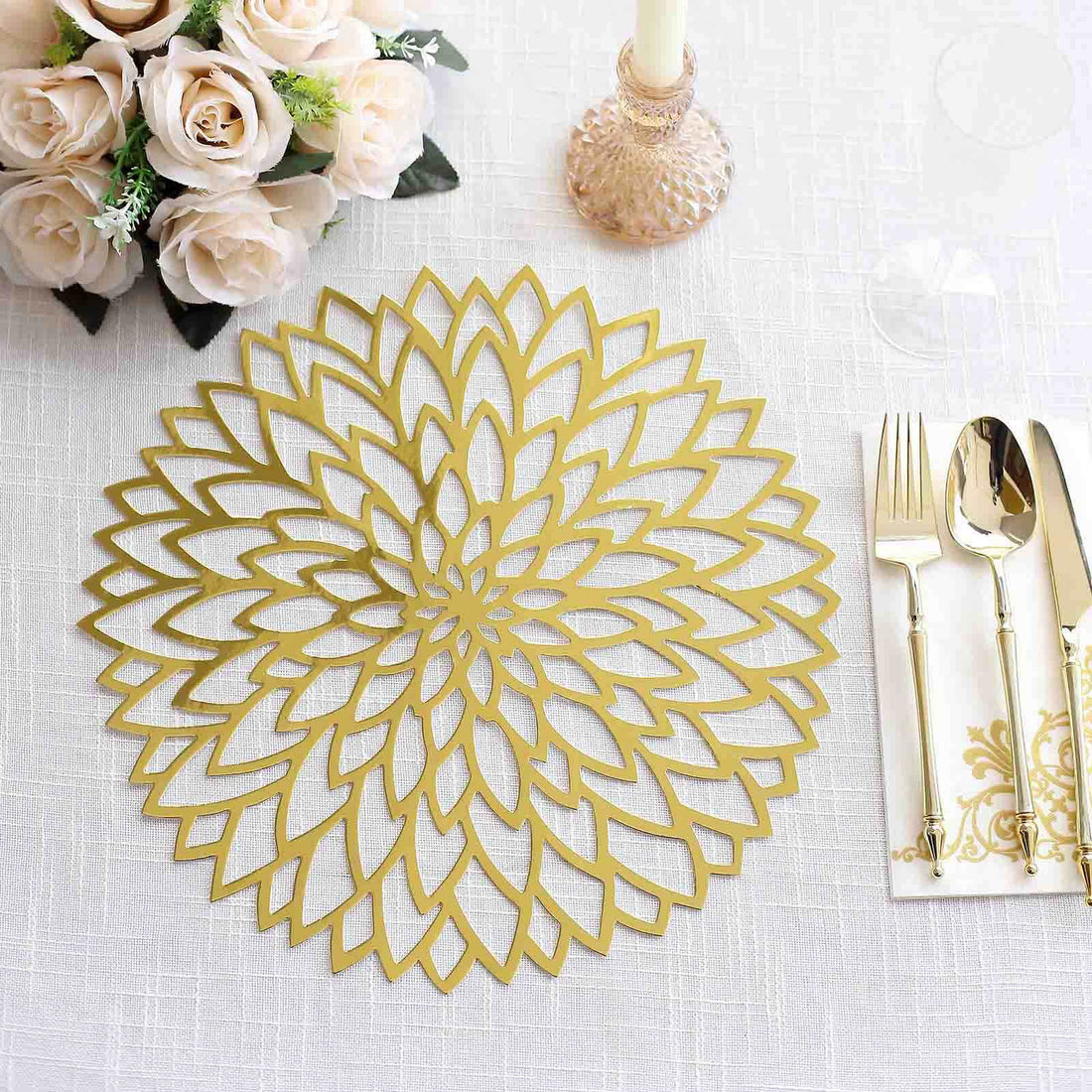 Gold flower-shaped placemat on a textured table with elegant dining setup.