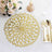 Gold flower-shaped placemat on a textured table with elegant dining setup.