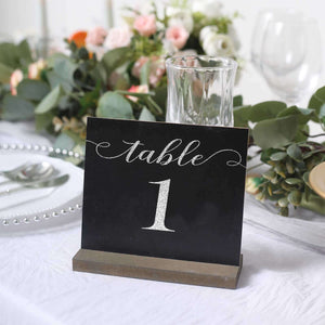 Table number sign with elegant silver lettering on a black background.