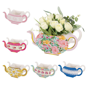 Colorful decorative teapots with floral designs, perfect for home decor.
