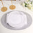 Elegant white dinner plate with gold accent on a glittery silver placemat.