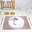 Elegant table setting with gold accents and a rose gold placemat.