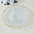 Elegant glass plate with textured design and gold rim