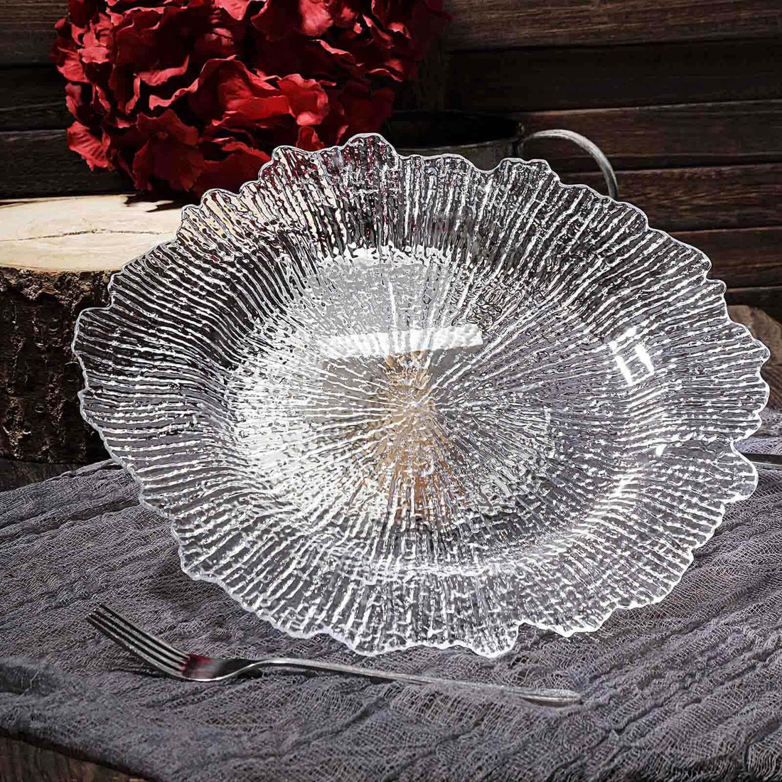 Textured clear glass serving plate with a floral design.