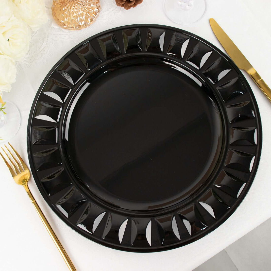 Elegant black decorative charger plate with intricate cutouts.