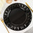 Elegant black decorative charger plate with intricate cutouts.