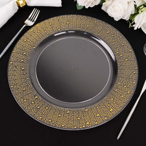 Elegant black plate with golden dotted rim on black table setting.