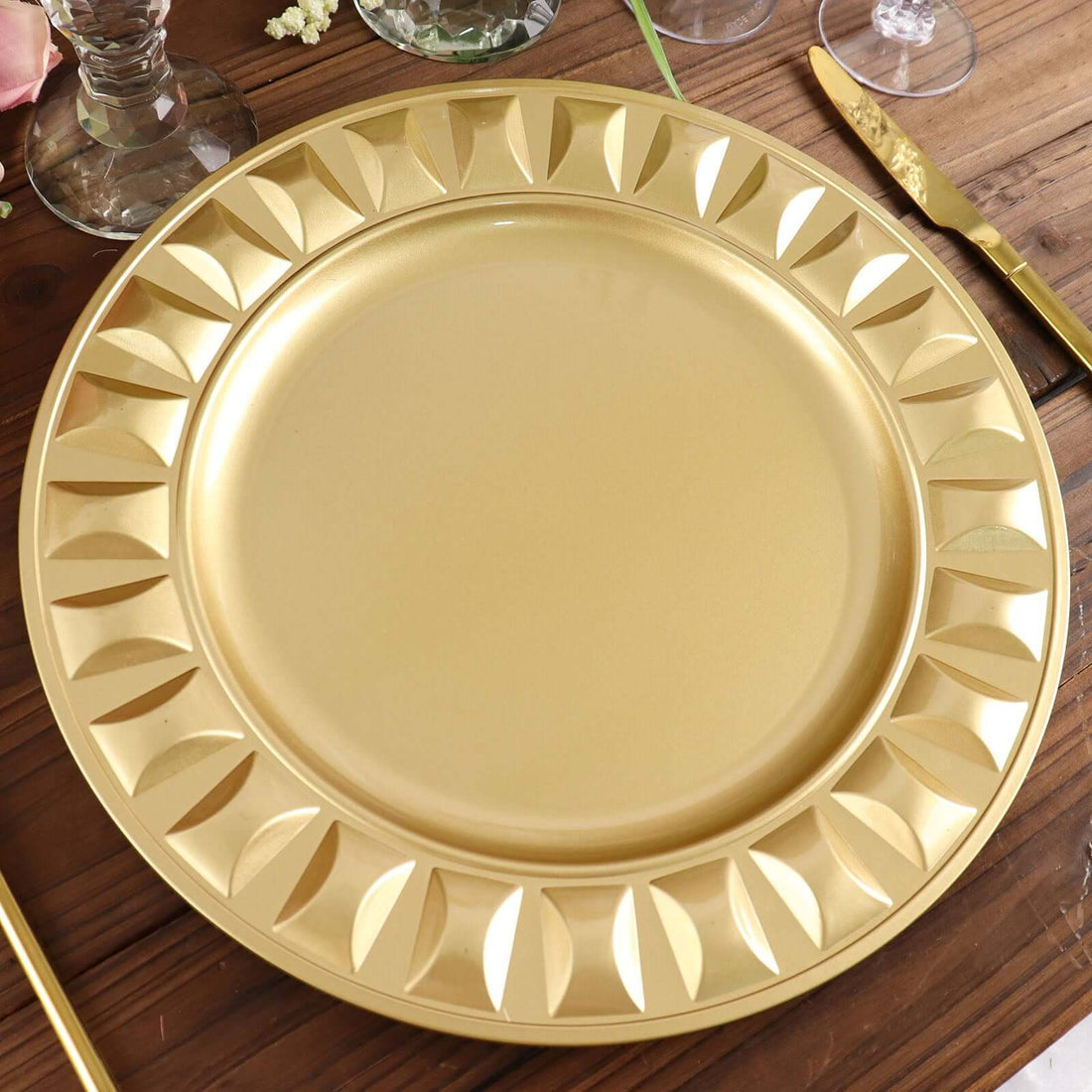 Gold decorative charger plate with elegant leaf design.