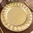 Gold decorative charger plate with elegant leaf design.