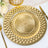 Gold decorative charger plate with intricate geometric patterns.