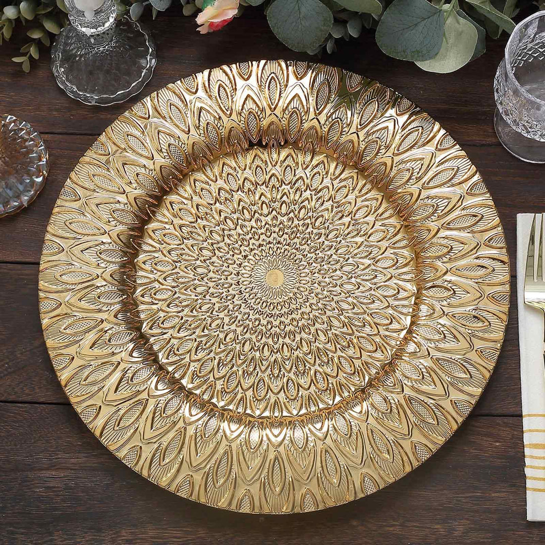 Gold decorative charger plate with intricate floral design.