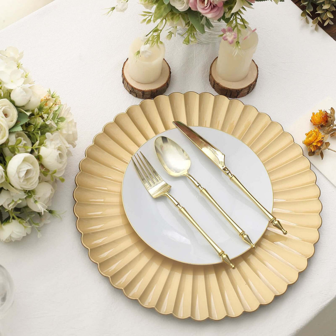 Elegant gold rimmed plate with matching cutlery on a table setting.