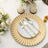 Elegant gold rimmed plate with matching cutlery on a table setting.