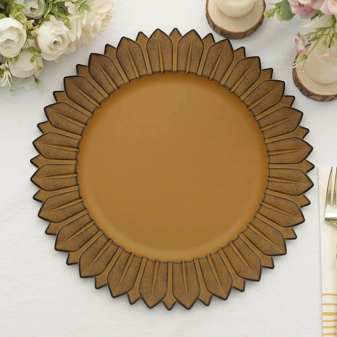 Brown sunflower-shaped decorative plate on a table.