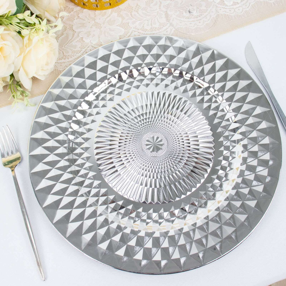 Elegant silver decorative charger plate with intricate geometric design.