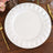 White decorative dinner plate on a rustic wooden table.